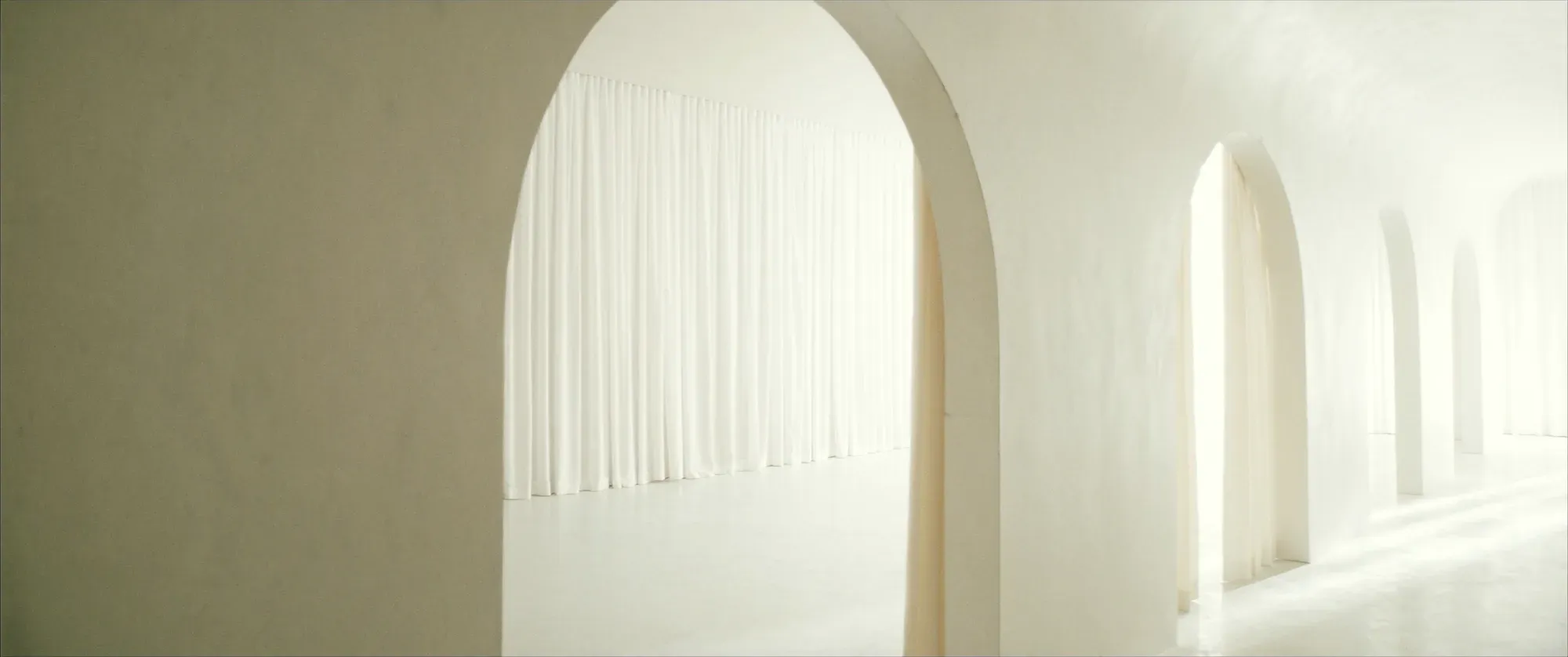 A light-filled arched hallway in the clinic